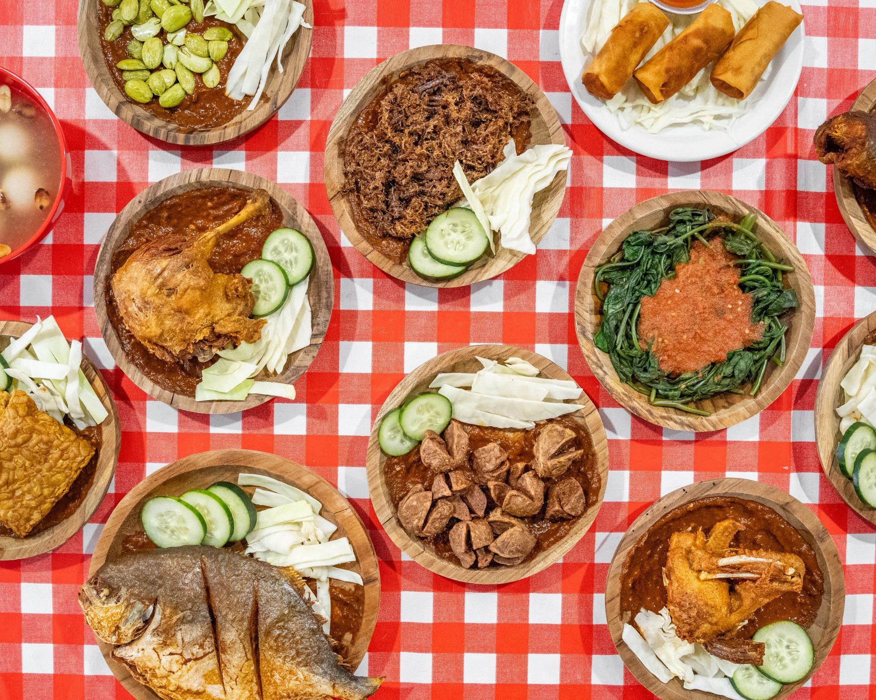 Assorted Indonesian dishes on a red checkered table